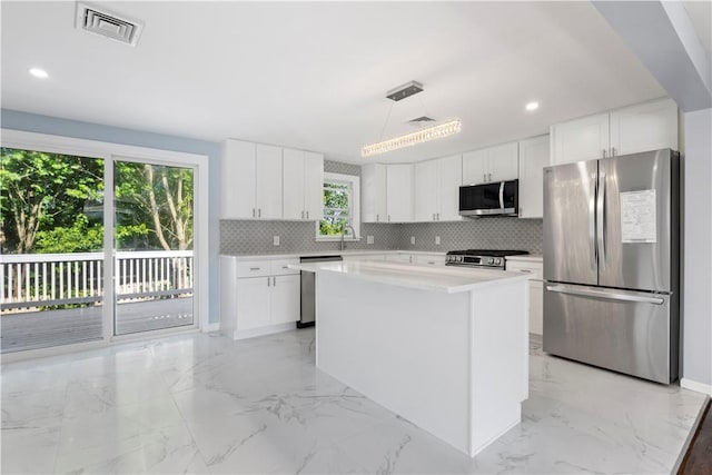 57 Wilson Ave, Johnston, RI 02919 - kitchen with stainless steel appliances, light marble finish flooring, tasteful backsplash, white cabinets, and recessed lighting