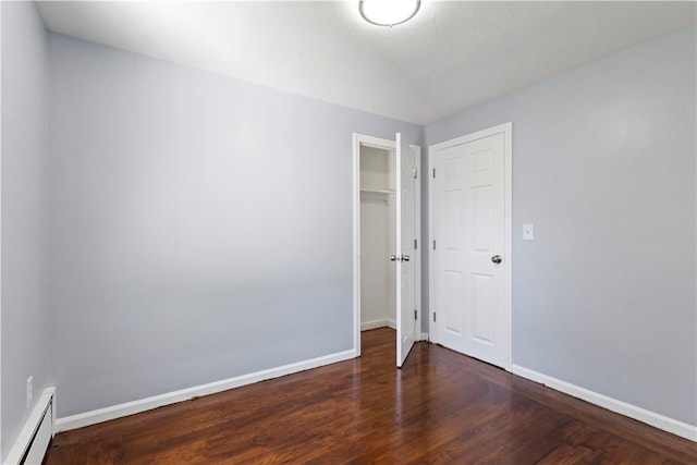 57 Wilson Ave, Johnston, RI 02919 - unfurnished bedroom featuring a baseboard heating unit, wood finished floors, and a closet