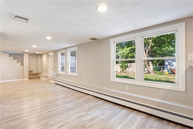 57 Wilson Ave, Johnston, RI 02919 - empty room with a baseboard heating unit, light wood-style floors, recessed lighting, and stairway