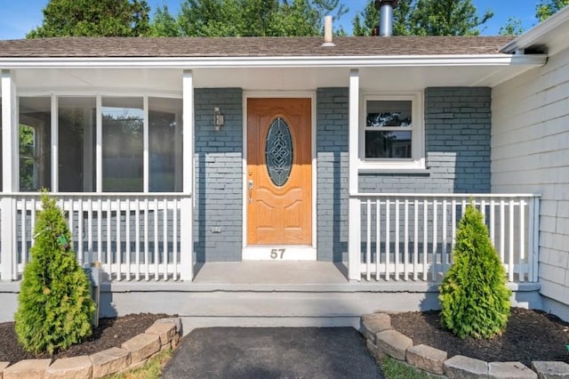 57 Wilson Ave, Johnston, RI 02919 - property entrance with a porch and brick siding