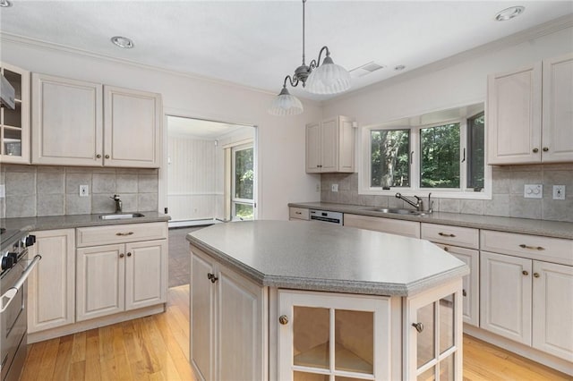 9 Beacon Hill Dr, Warwick, RI 02886 - kitchen with stainless steel range, light wood-style flooring, plenty of natural light, decorative backsplash, and ornamental molding