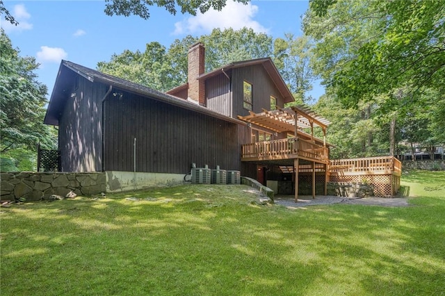 9 Beacon Hill Dr, Warwick, RI 02886 - back of house featuring a chimney, a pergola, a wooden deck, and a lawn