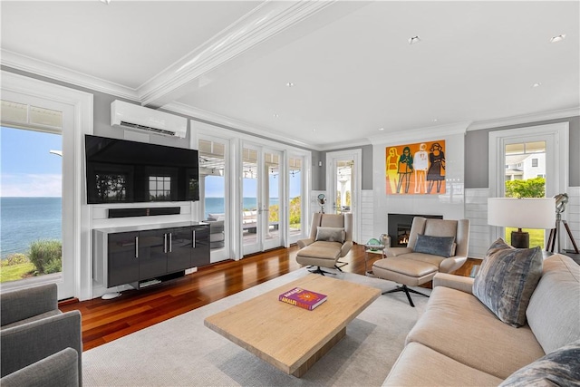 1210 Graces Cove Rd, Block Island, RI 02807 - living room with a wall mounted air conditioner, wood finished floors, crown molding, a fireplace, and recessed lighting
