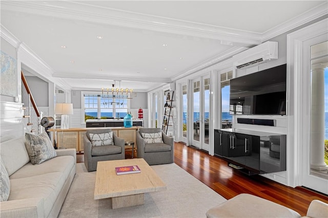 1210 Graces Cove Rd, Block Island, RI 02807 - living area featuring an AC wall unit, wood finished floors, a chandelier, ornamental molding, and recessed lighting