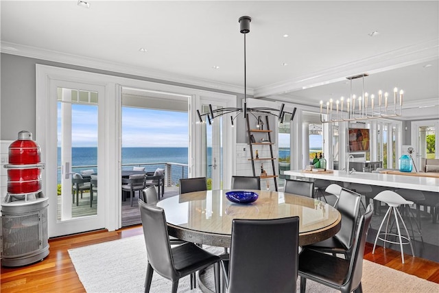 1210 Graces Cove Rd, Block Island, RI 02807 - dining area featuring ornamental molding, light wood-style flooring, and a water view