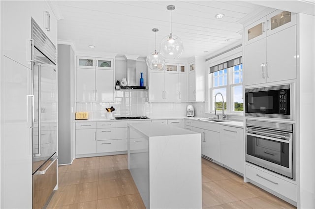 1210 Graces Cove Rd, Block Island, RI 02807 - kitchen with black appliances, wall chimney exhaust hood, backsplash, light countertops, and white cabinetry