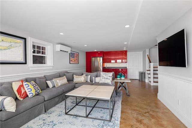 1210 Graces Cove Rd, Block Island, RI 02807 - living room with a wall unit AC, concrete floors, stairway, wainscoting, and recessed lighting