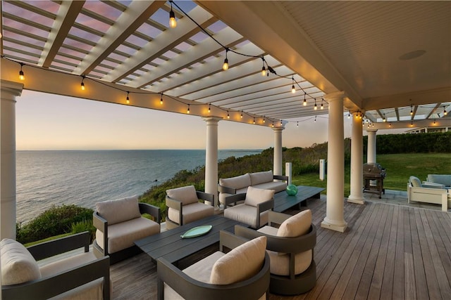 1210 Graces Cove Rd, Block Island, RI 02807 - deck at dusk featuring an outdoor hangout area, a water view, and a pergola
