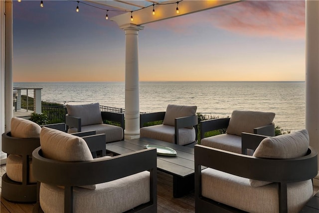 1210 Graces Cove Rd, Block Island, RI 02807 - patio terrace at dusk with a water view and an outdoor living space