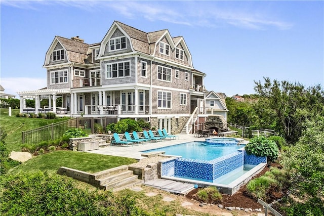 1210 Graces Cove Rd, Block Island, RI 02807 - rear view of house with a patio area, stairs, a gambrel roof, and a pool with connected hot tub