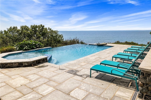 1210 Graces Cove Rd, Block Island, RI 02807 - view of swimming pool featuring a patio area, a pool with connected hot tub, and a water view