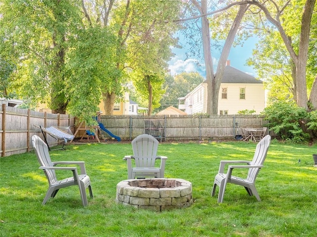 19 Revere Ave, West Warwick, RI 02893 - fenced backyard with an outdoor fire pit and a playground