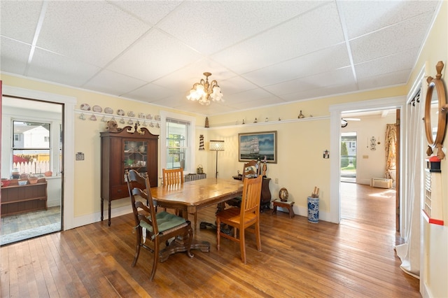 49 Palmer Ave, Warwick, RI 02889 - dining area featuring a drop ceiling, wood-type flooring, and a chandelier