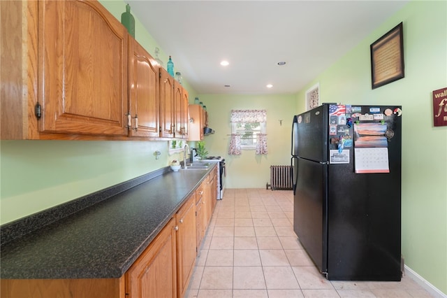 49 Palmer Ave, Warwick, RI 02889 - kitchen with freestanding refrigerator, radiator, light tile patterned floors, dark countertops, and recessed lighting