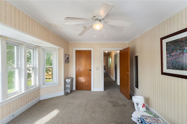 49 Palmer Ave, Warwick, RI 02889 - empty room with radiator heating unit, crown molding, wallpapered walls, carpet, and ceiling fan
