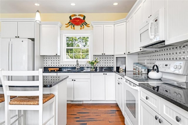 37 Teal Rd, South Kingstown, RI 02879 - kitchen with white appliances, dark countertops, wood finished floors, backsplash, and recessed lighting