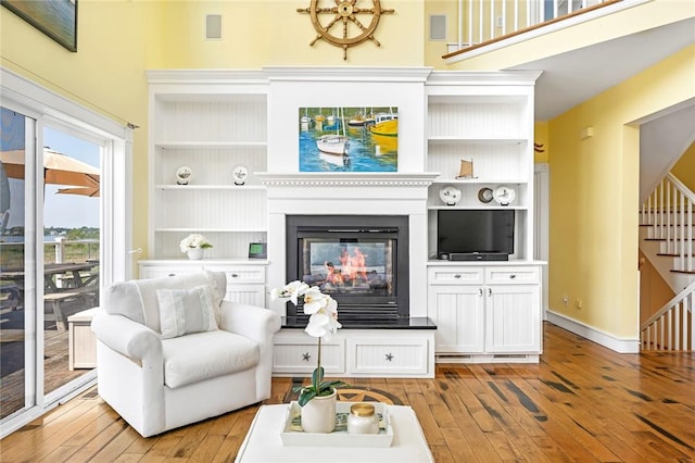 37 Teal Rd, South Kingstown, RI 02879 - living room with light wood finished floors, stairs, a multi sided fireplace, and built in features