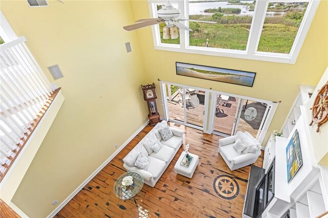 37 Teal Rd, South Kingstown, RI 02879 - living area featuring a towering ceiling, plenty of natural light, ceiling fan, a water view, and hardwood / wood-style flooring