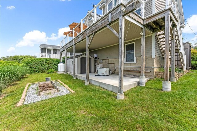 37 Teal Rd, South Kingstown, RI 02879 - back of house featuring a shed, a vegetable garden, a lawn, and a patio