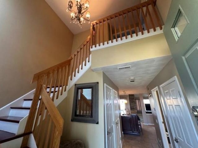 88 Nipmuc Trl Unit C, North Providence, RI 02904 - stairway with a chandelier and tile patterned flooring