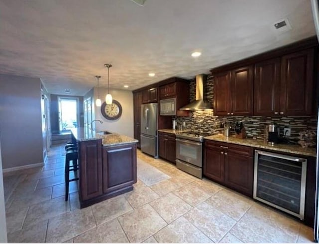 88 Nipmuc Trl Unit C, North Providence, RI 02904 - kitchen with wall chimney exhaust hood, beverage cooler, stainless steel appliances, backsplash, and light stone countertops