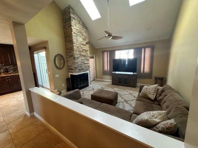 88 Nipmuc Trl Unit C, North Providence, RI 02904 - living room with a skylight, light tile patterned floors, high vaulted ceiling, healthy amount of natural light, and a stone fireplace