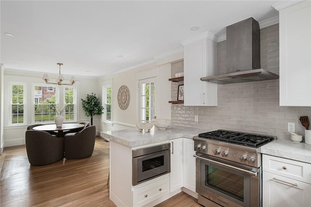 175 Freeman Pkwy, Providence, RI 02906 - kitchen featuring wall chimney exhaust hood, stainless steel range, open shelves, a chandelier, and light countertops