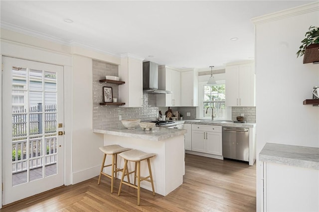 175 Freeman Pkwy, Providence, RI 02906 - kitchen with wall chimney exhaust hood, stainless steel dishwasher, open shelves, a peninsula, and white cabinetry