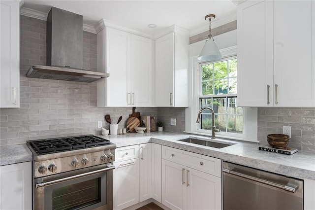 175 Freeman Pkwy, Providence, RI 02906 - kitchen with stainless steel appliances, wall chimney range hood, backsplash, white cabinetry, and ornamental molding