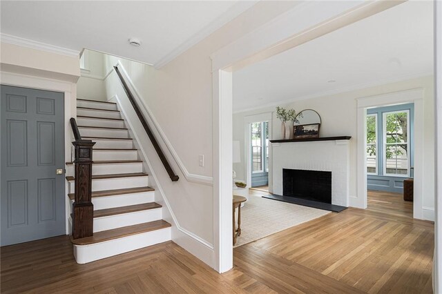 175 Freeman Pkwy, Providence, RI 02906 - staircase with ornamental molding, plenty of natural light, a brick fireplace, and wood finished floors