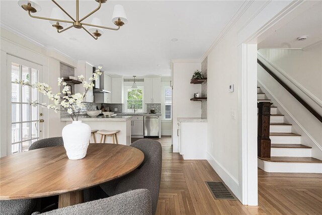 175 Freeman Pkwy, Providence, RI 02906 - dining room featuring a chandelier, stairway, and ornamental molding