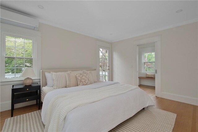 175 Freeman Pkwy, Providence, RI 02906 - bedroom with a wall mounted air conditioner, wood finished floors, and ornamental molding