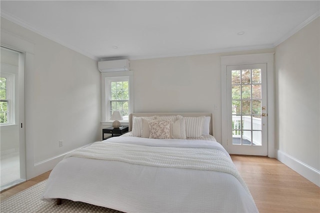 175 Freeman Pkwy, Providence, RI 02906 - bedroom with a wall unit AC, access to outside, light wood finished floors, and crown molding