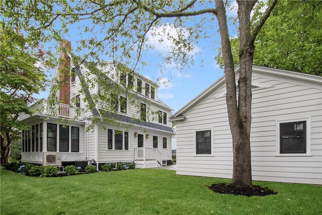 175 Freeman Pkwy, Providence, RI 02906 - back of house with a chimney, a lawn, and a sunroom