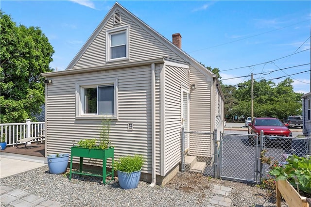 75 Crescent Ave, Cranston, RI 02910 - view of side of property featuring a chimney and a gate