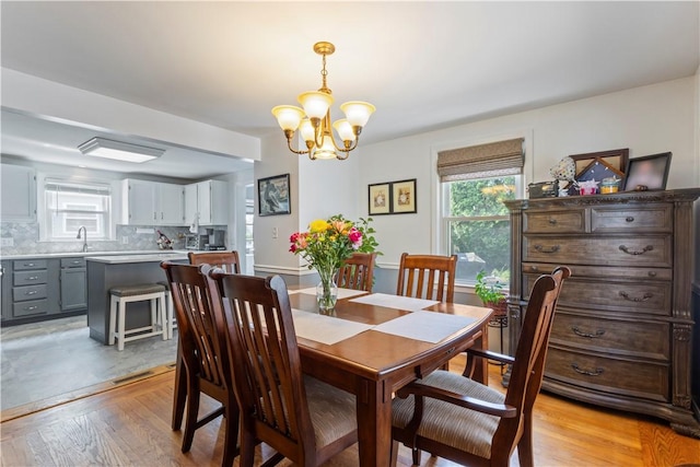 75 Crescent Ave, Cranston, RI 02910 - dining area featuring a chandelier, light wood finished floors, and plenty of natural light