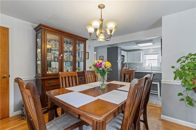 75 Crescent Ave, Cranston, RI 02910 - dining room featuring a chandelier and light wood-type flooring