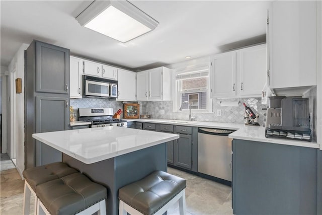 75 Crescent Ave, Cranston, RI 02910 - kitchen with stainless steel appliances, a breakfast bar, a center island, and decorative backsplash