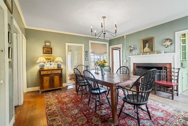 15 N Main St, Freetown, MA 02702 - dining room featuring hardwood / wood-style floors, a fireplace, ornamental molding, and a chandelier