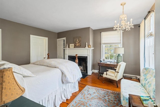 15 N Main St, Freetown, MA 02702 - bedroom with a chandelier, wood finished floors, and a fireplace