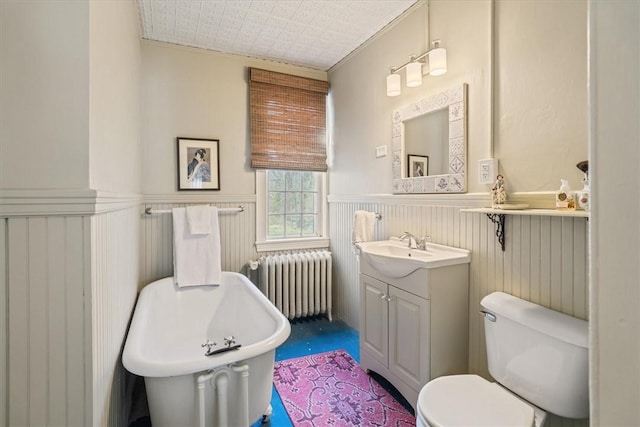 15 N Main St, Freetown, MA 02702 - bathroom featuring radiator heating unit, wainscoting, a freestanding bath, and vanity