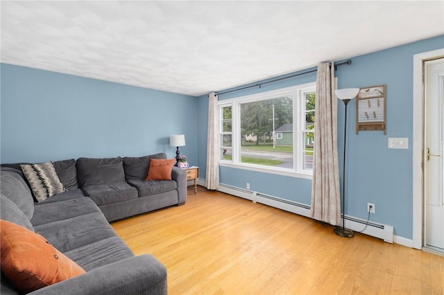 120 Landis Dr, Warwick, RI 02818 - living area with wood finished floors and a baseboard heating unit