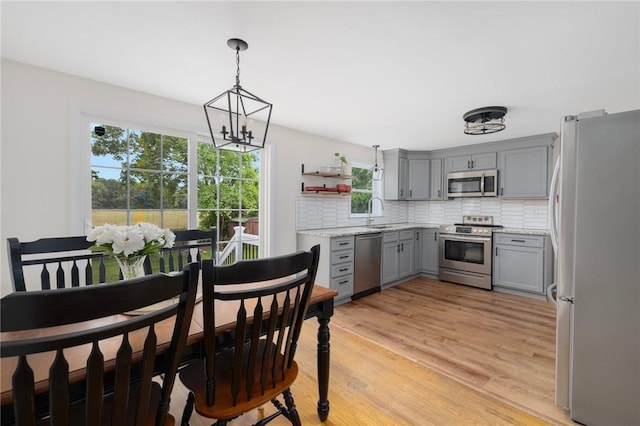 120 Landis Dr, Warwick, RI 02818 - dining room featuring a chandelier and light wood-type flooring
