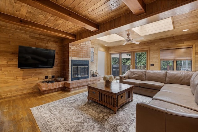788 Namquid Dr, Warwick, RI 02888 - living area featuring a wooden ceiling with exposed beams, wood walls, hardwood / wood-style floors, a fireplace, and ceiling fan