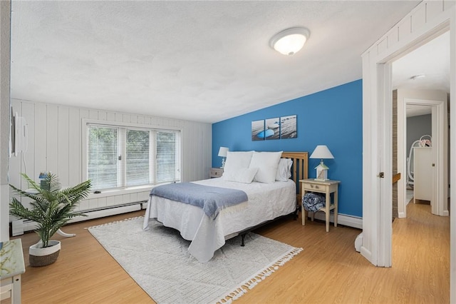 788 Namquid Dr, Warwick, RI 02888 - bedroom with a baseboard radiator and light wood-style floors