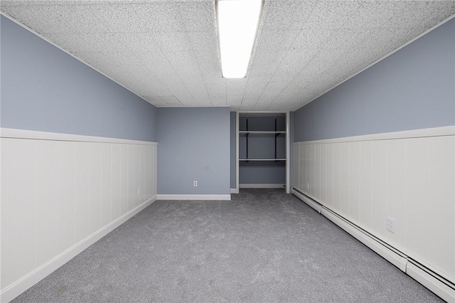 788 Namquid Dr, Warwick, RI 02888 - unfurnished bedroom featuring baseboard heating, carpet, and wainscoting