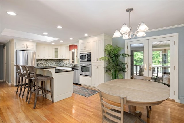 70 High Ridge Dr, Cumberland, RI 02864 - kitchen with stainless steel appliances, white cabinetry, a chandelier, a center island, and recessed lighting
