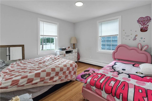 101 Benefit St, Pawtucket, RI 02860 - bedroom featuring a baseboard heating unit and light wood-style flooring