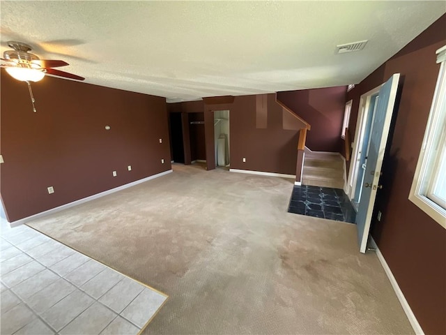 511 Child St Unit 101, Warren, RI 02885 - unfurnished living room with stairs, ceiling fan, carpet floors, and a textured ceiling