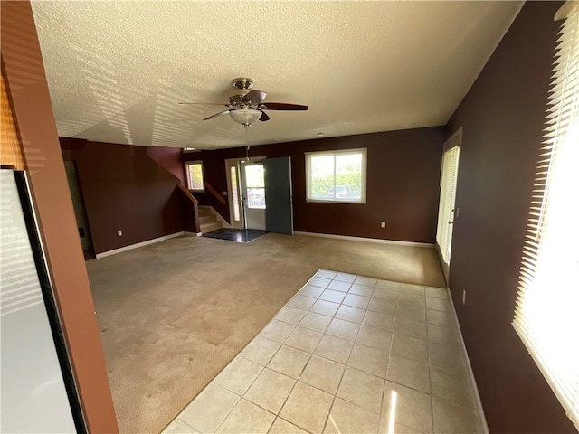 511 Child St Unit 101, Warren, RI 02885 - spare room with carpet, a ceiling fan, a textured ceiling, stairway, and tile patterned floors